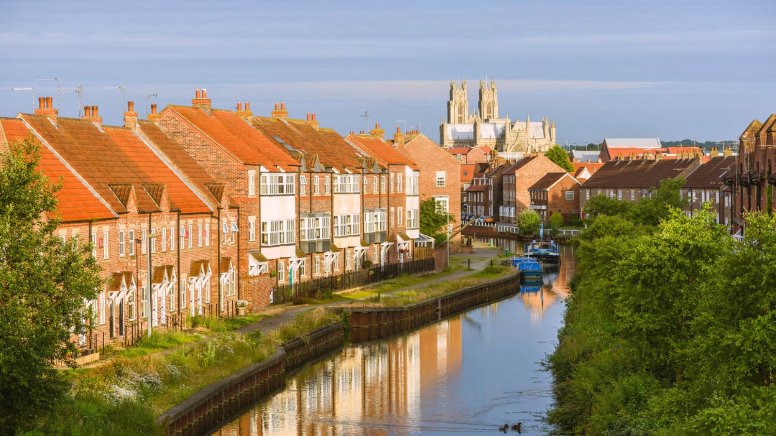 Beverley Minster and townhouses by the Beck canal on a clear morning in Beverley, East Yorkshire