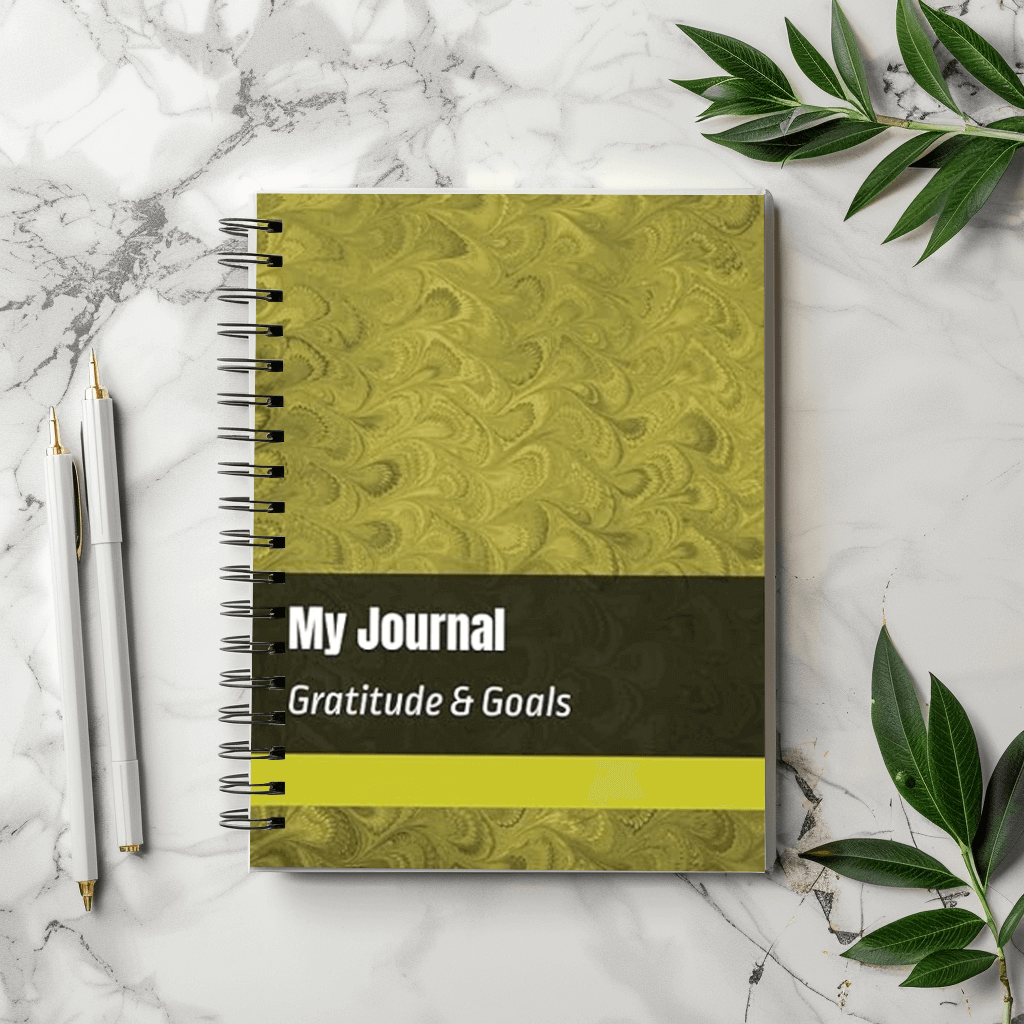 Gratitude and Goals Journal on a table with a pen
